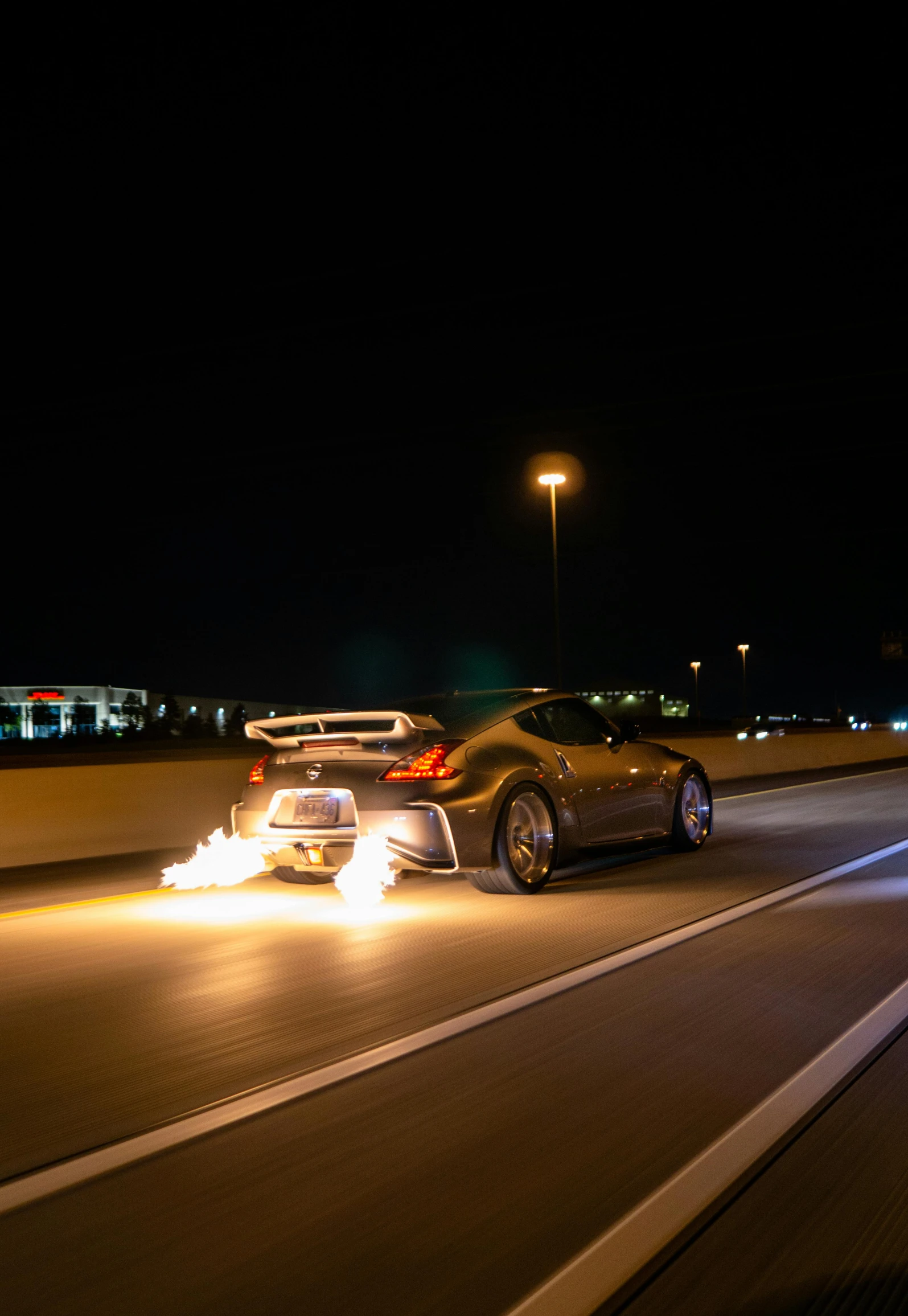 two vehicles traveling down an highway in the dark