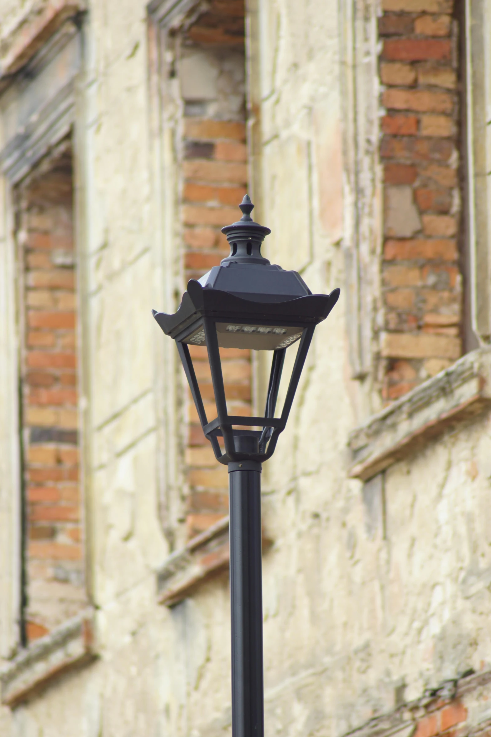 a street lamp in front of a brick building