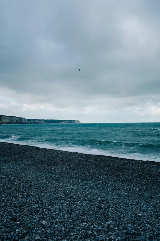 waves coming up onto the shore of a large body of water