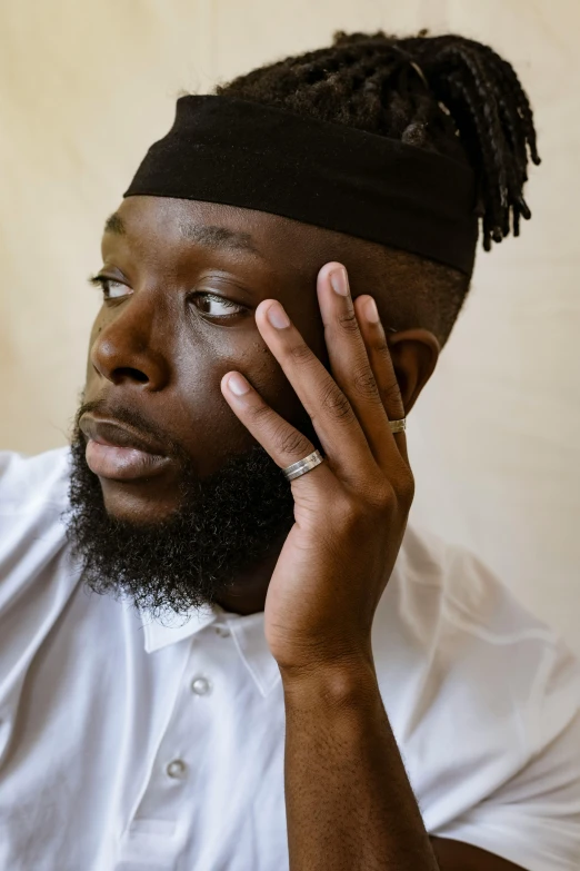 a man with dreadlocks talking on a cellphone