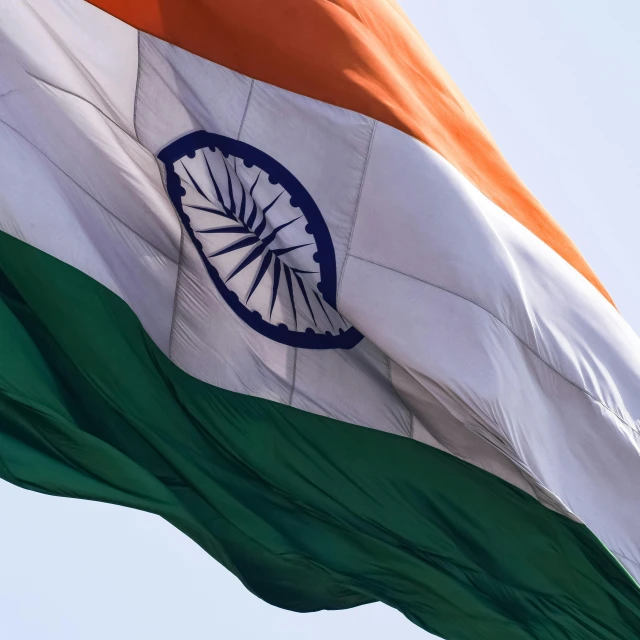 the colors of india flag against a clear blue sky