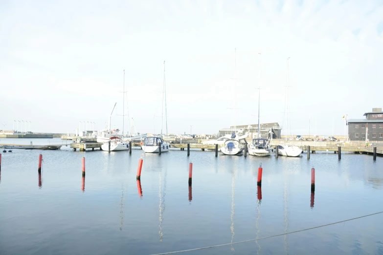 boats docked in the water near docks and buildings