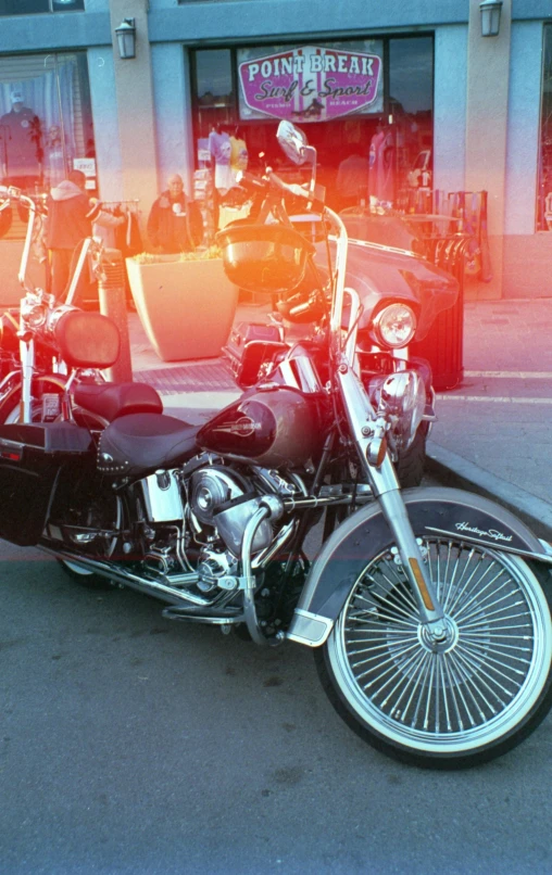 an old fashioned motorcycle sits in a parking lot