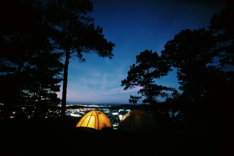 the night with three tents and trees all by themselves