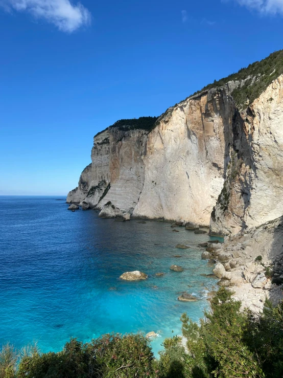 a blue body of water near a cliff