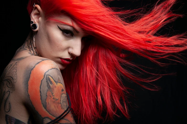 a woman with tattoos and a red hair