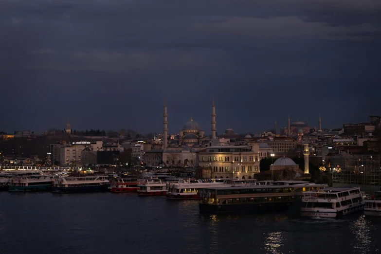 several ships in the water in a large city