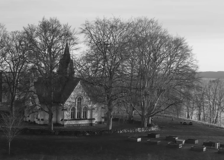 an old house near the water in a black and white picture