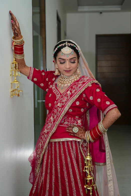 a beautiful woman in a red bridal gown posing