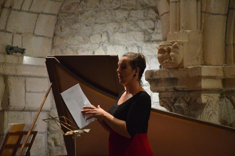 a woman standing next to a easel in a large building