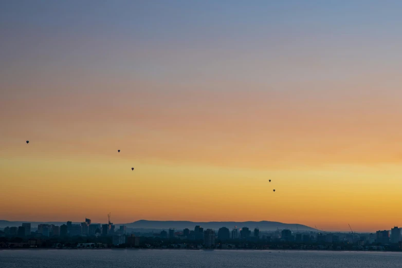 the birds are flying low above the city