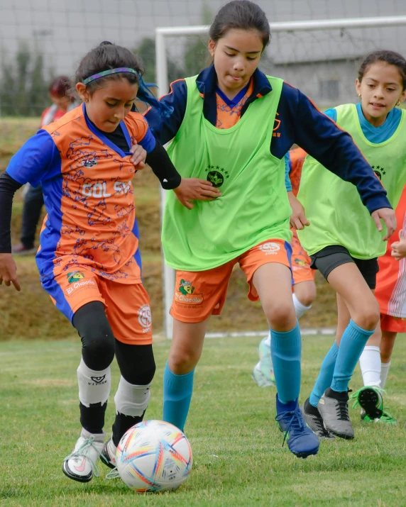 a group of s are playing soccer together