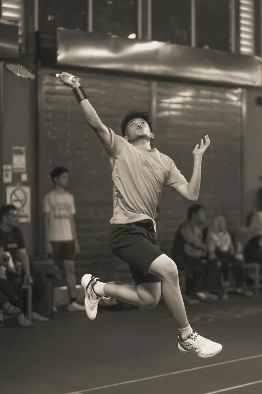 a man jumping in the air on top of a tennis court