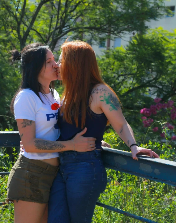 a woman kissing another woman with her mouth