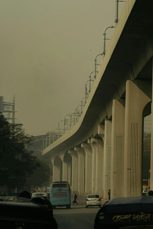 cars driving by on a highway with many rails on the side of it