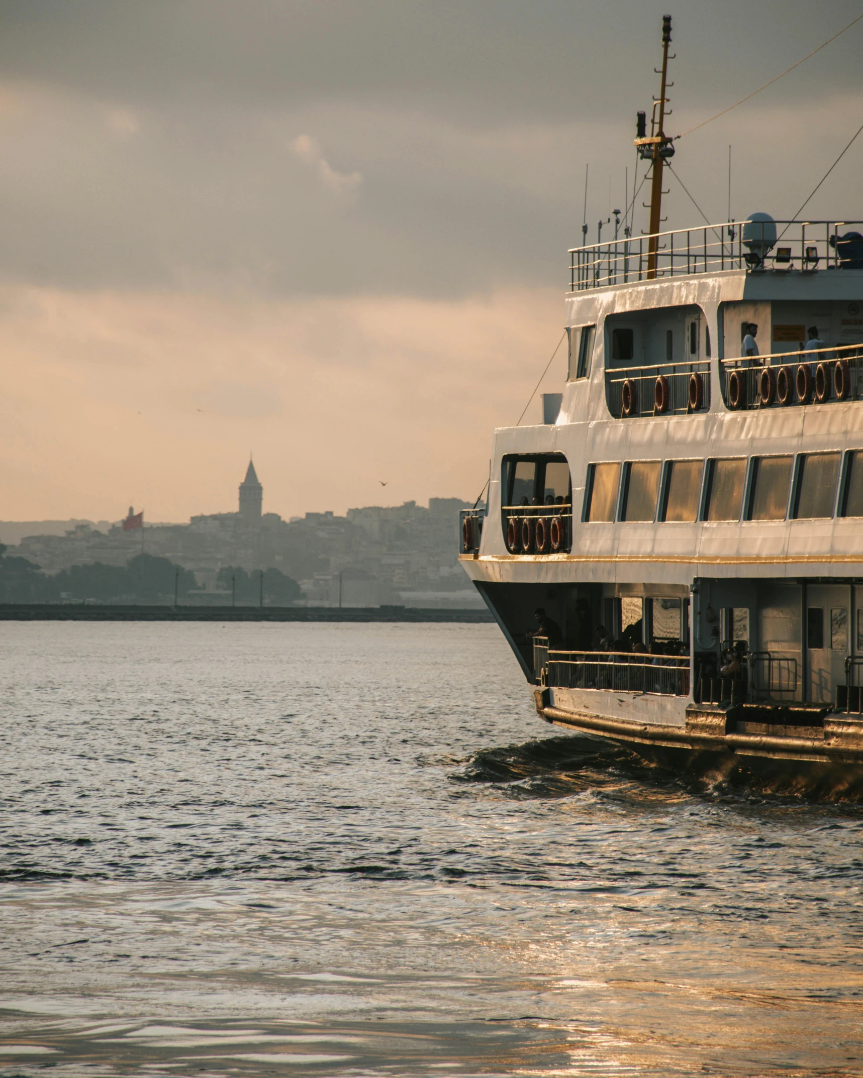 a ferry boat floating across the water by some buildings