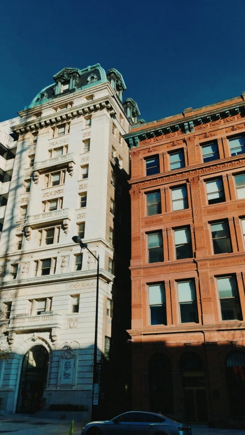 a car parked in front of two tall buildings