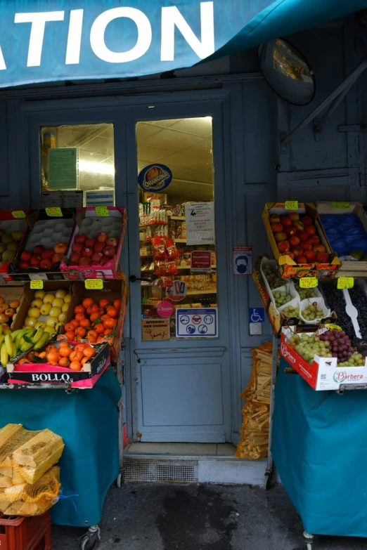 some fruit are on display at the entrance to a store