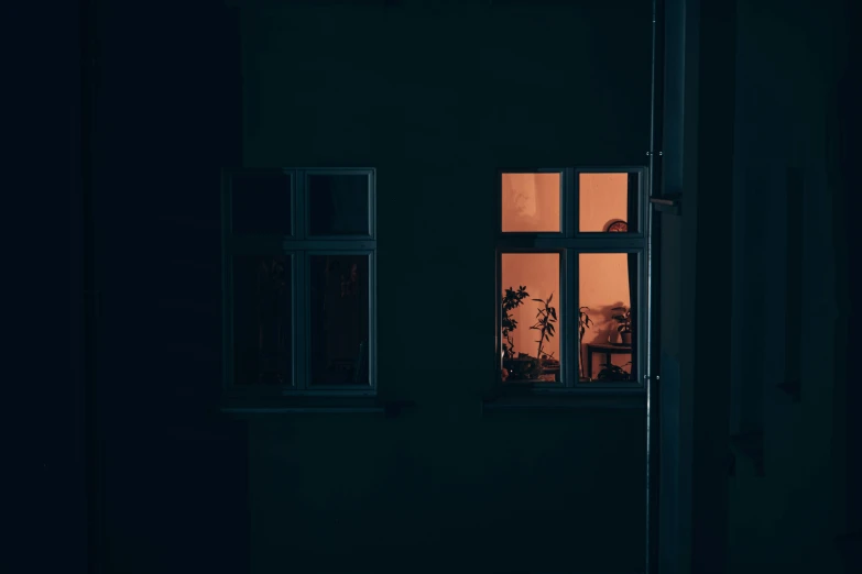 a room with the darkest walls, and a light shining through a window