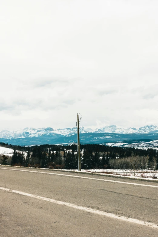 an empty road in a mountainous area with no cars