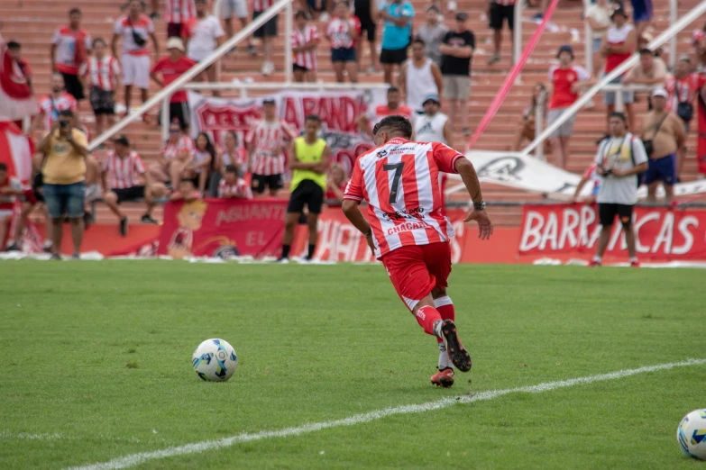 an athletic player in red uniform going after the ball