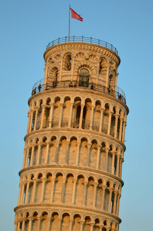 a large tower with a flag and the top