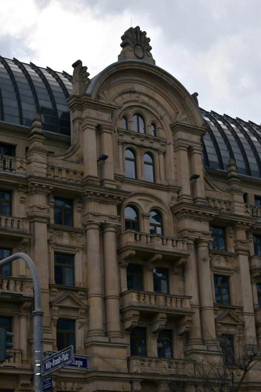 a large building with many windows and a sky background