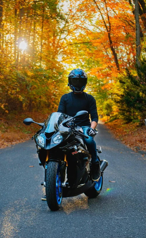 a person wearing a helmet and riding on a motorcycle