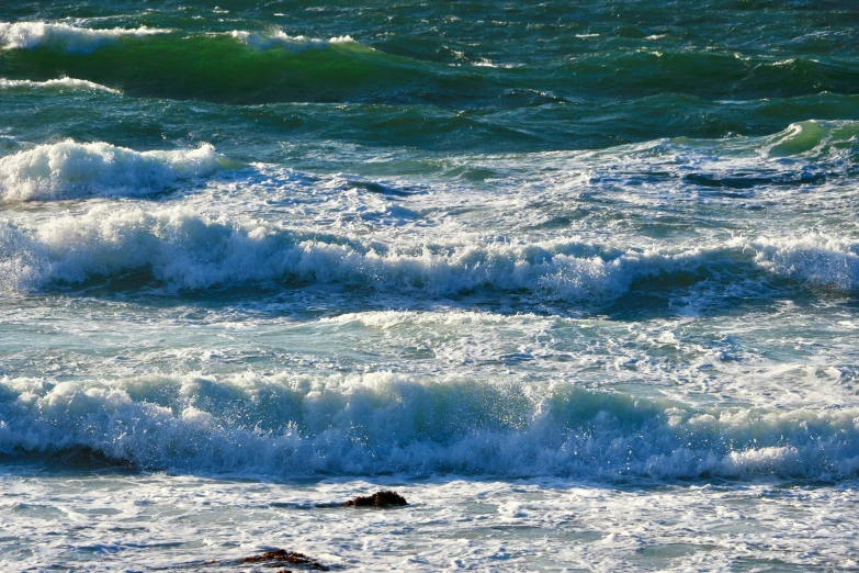 people on the ocean near some very rough waves