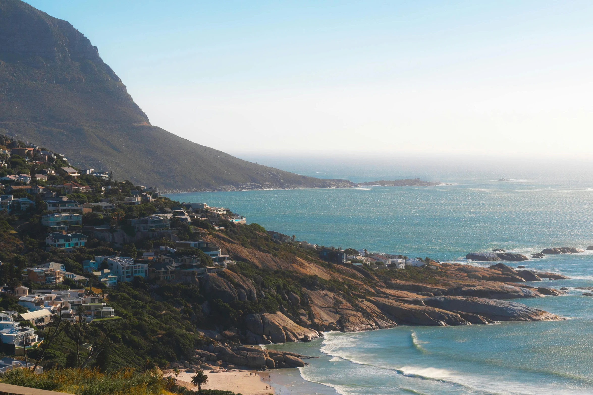 a view of the ocean and houses by the shoreline