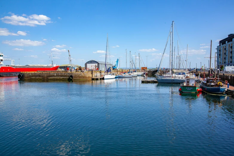 boats are parked in the water near a pier