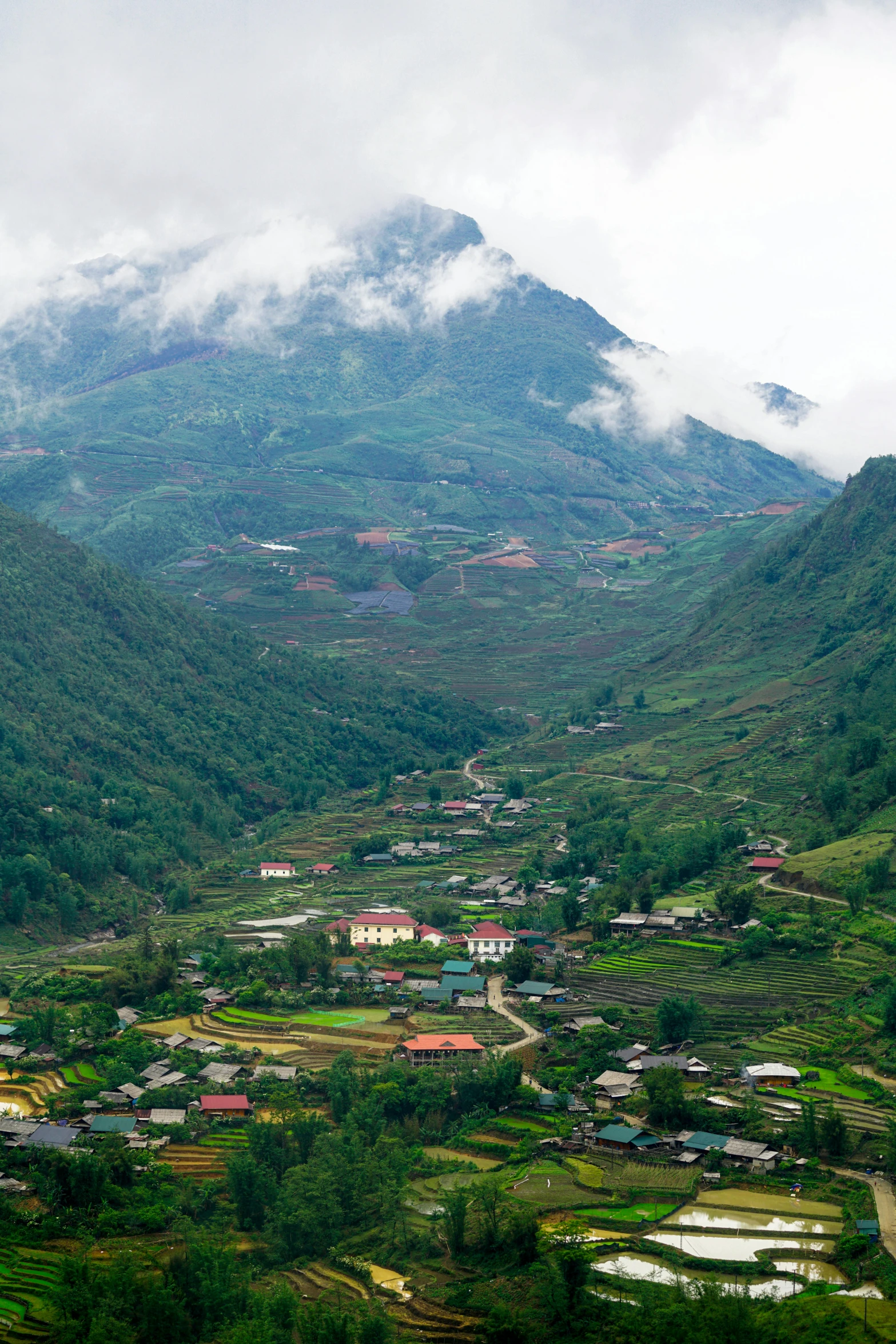 a small town nestled beneath a lush green hill