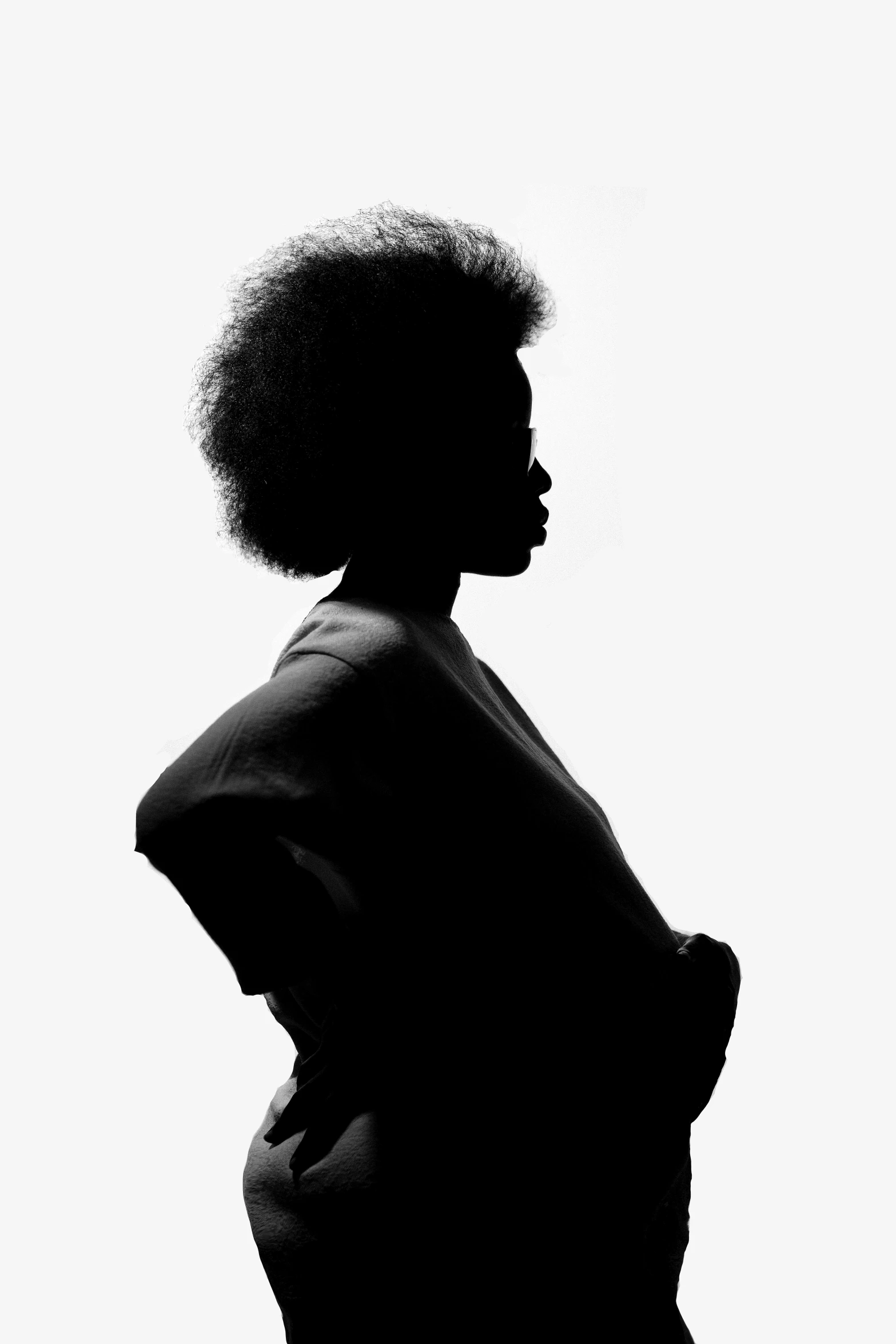 a woman with afro hair is standing up