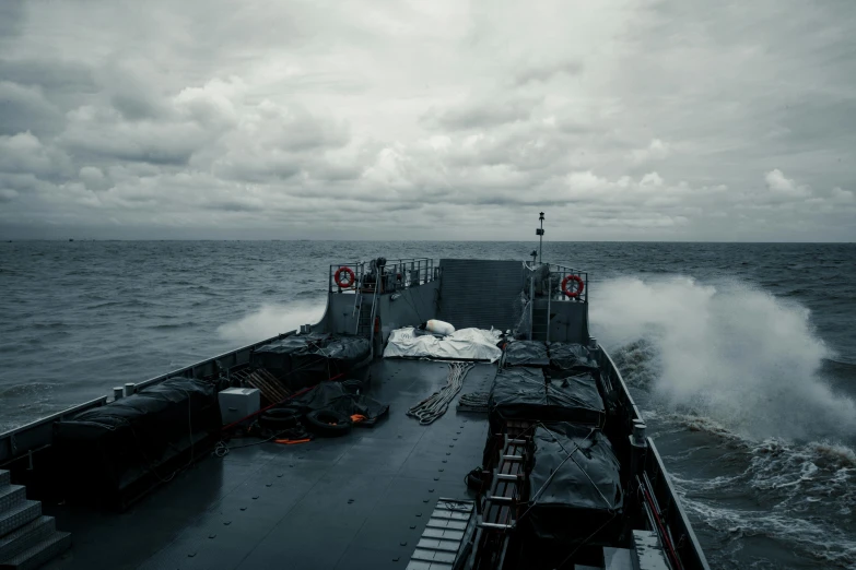 a ship traveling on top of an ocean covered in fog