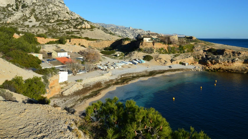 a small bay on the shore with a mountain in the background