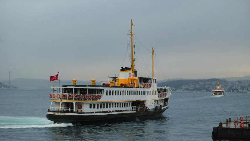 the large boat has paddles and flags on it