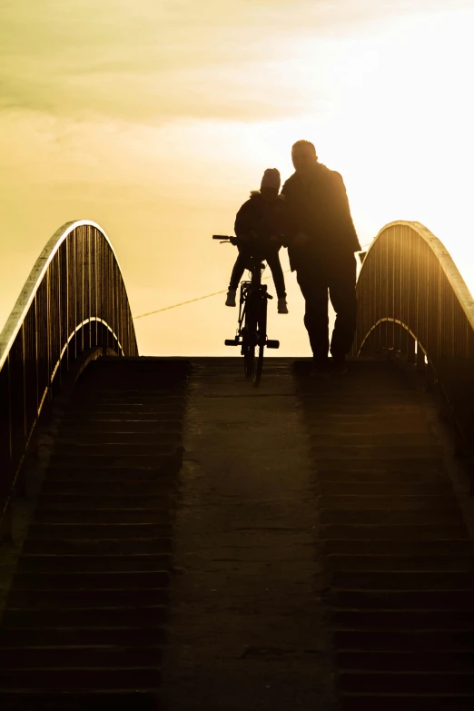 a man and child are standing on a bridge