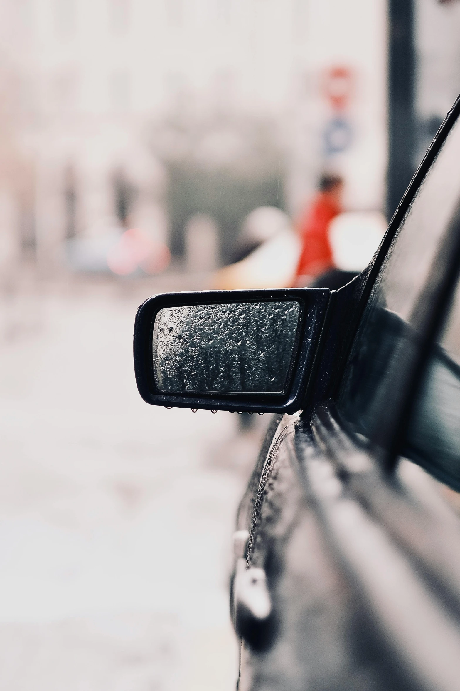 a rearview mirror with a blurry background and a person holding a walkie talkie