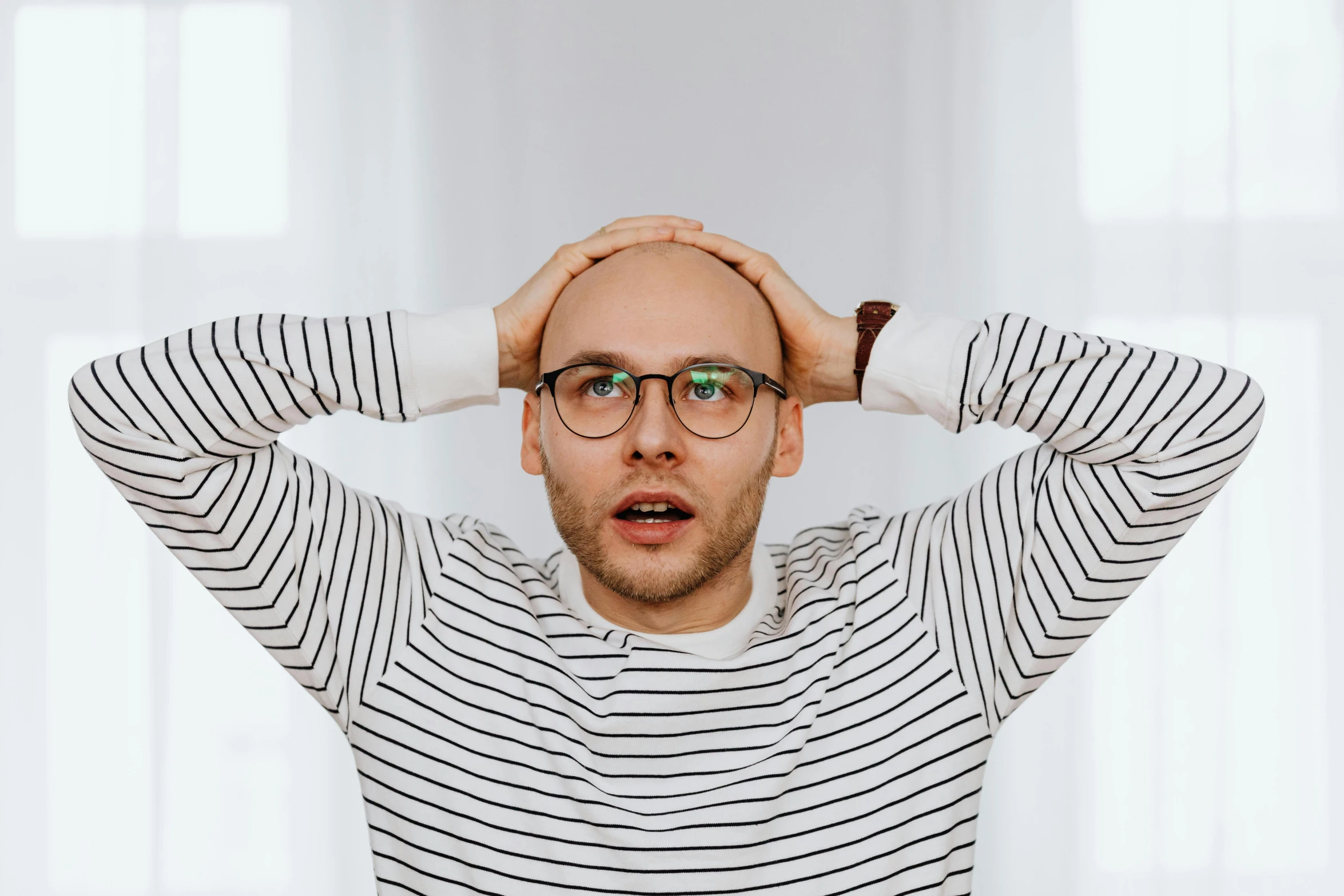 a man is covering his eyes with his hands