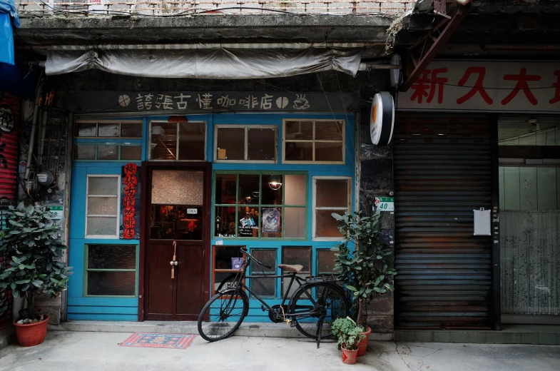 a bike sits outside a building with a wooden door