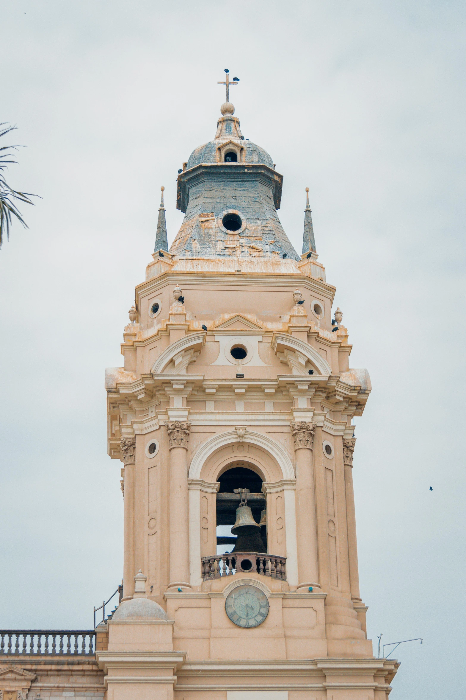 a tall clock tower is shown in front of some buildings