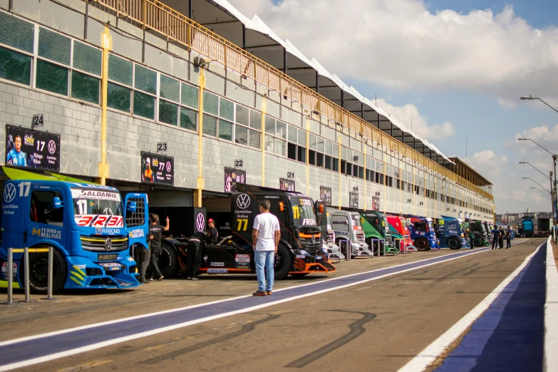 a person walks near many colorful trucks outside