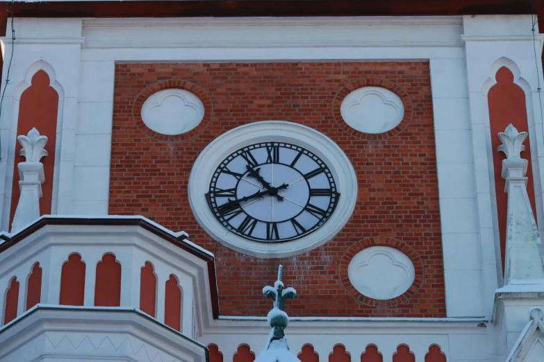 a clock mounted on the side of a building next to stairs