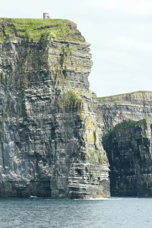 an island in a body of water with cliffs on either side