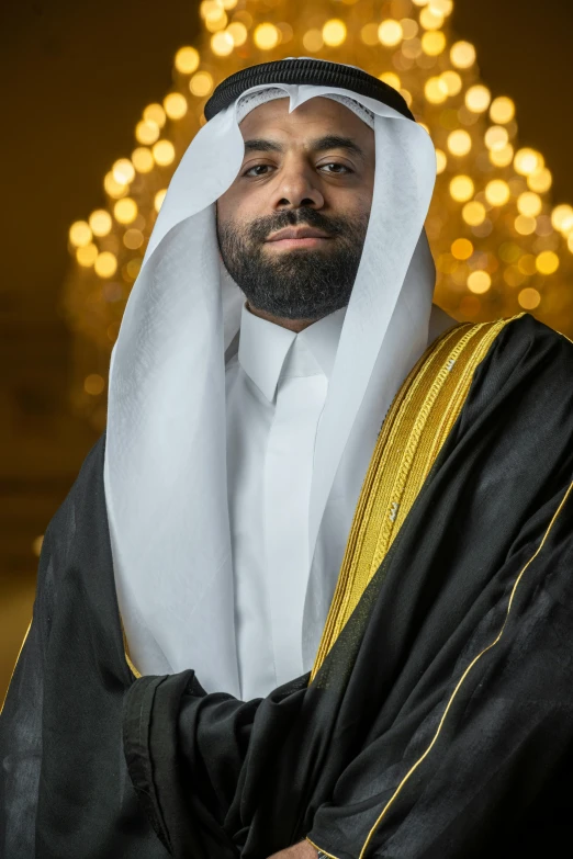 a man poses for the camera wearing a large black and white robe