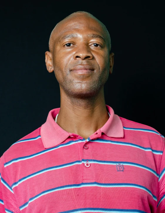 a close up of a person wearing a pink shirt