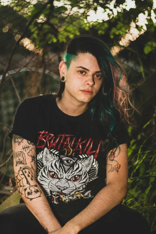 a girl with green hair and tattoos posing for a po