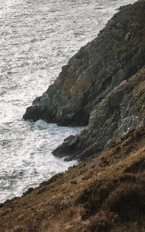 there is a small boat on the water and some rocks