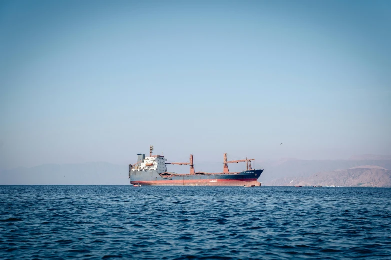 an orange boat is sitting on the calm water