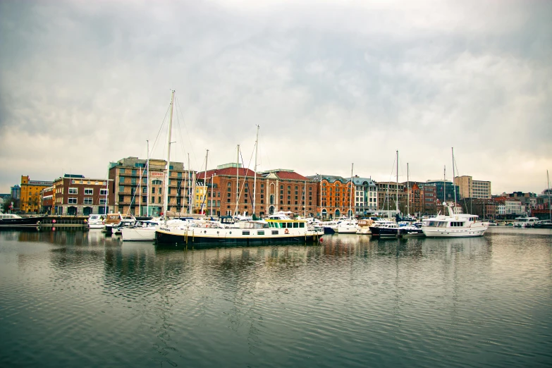 several boats in a body of water with the city in the background